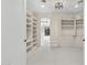 Bright walk-in closet with custom built-in shelving and hanging racks, and neutral carpet at 6467 E Sierra Vista Dr, Paradise Valley, AZ 85253