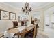 Formal dining room with decorative chandelier, arched doorways, and views into other living spaces at 6467 E Sierra Vista Dr, Paradise Valley, AZ 85253