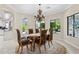 Elegant dining room with a round rug, decorative chandelier, and views of the landscaped yard at 6467 E Sierra Vista Dr, Paradise Valley, AZ 85253