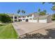 Majestic two-story home featuring a spacious driveway and ample parking, surrounded by mature trees at 6467 E Sierra Vista Dr, Paradise Valley, AZ 85253