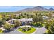 Majestic estate with circular driveway, lush landscaping and mountain views in the background at 6467 E Sierra Vista Dr, Paradise Valley, AZ 85253