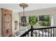 Hallway with fireplace, chandelier, and views of the pool at 6467 E Sierra Vista Dr, Paradise Valley, AZ 85253