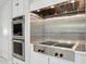 Modern kitchen with stainless steel oven, sleek cooktop, and updated cabinetry at 6467 E Sierra Vista Dr, Paradise Valley, AZ 85253