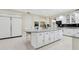 Spacious white kitchen featuring a large center island with granite countertops and modern appliances at 6467 E Sierra Vista Dr, Paradise Valley, AZ 85253