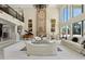 Expansive living room with a grand fireplace, piano, and elegant white sofas at 6467 E Sierra Vista Dr, Paradise Valley, AZ 85253