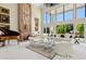 Bright living room featuring tall windows, a fireplace, and elegant white sofas at 6467 E Sierra Vista Dr, Paradise Valley, AZ 85253