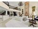 Spacious living room with a grand staircase, fireplace, and elegant white sofas at 6467 E Sierra Vista Dr, Paradise Valley, AZ 85253