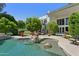 Sparkling pool area with well-manicured landscaping, sunbathing deck, and outdoor spiral staircase at 6467 E Sierra Vista Dr, Paradise Valley, AZ 85253