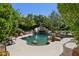 Lush backyard showcasing a stunning freeform pool with a rock waterfall and beautiful landscaping at 6467 E Sierra Vista Dr, Paradise Valley, AZ 85253