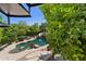 Outdoor living featuring a sparkling pool, rock waterfall, and comfortable seating area at 6467 E Sierra Vista Dr, Paradise Valley, AZ 85253