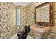 Unique powder room featuring a stone pedestal sink, patterned wallpaper, and stylish fixtures at 6467 E Sierra Vista Dr, Paradise Valley, AZ 85253