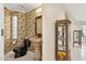 Elegant powder room with decorative wallpaper, unique sink, and a glimpse into the main house at 6467 E Sierra Vista Dr, Paradise Valley, AZ 85253