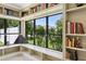 Cozy window seat surrounded by built-in bookshelves, offering scenic outdoor views at 6467 E Sierra Vista Dr, Paradise Valley, AZ 85253