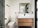 Modern bathroom features a sleek vanity with wood drawers, matte black fixtures, and a toilet at 7100 N 47Th St, Paradise Valley, AZ 85253