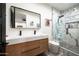 Bathroom featuring double sinks, modern fixtures, and a glass-enclosed shower with subway tile at 7100 N 47Th St, Paradise Valley, AZ 85253