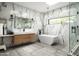 Elegant bathroom featuring a freestanding tub, frameless shower, and marble accent wall at 7100 N 47Th St, Paradise Valley, AZ 85253