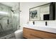 Contemporary bathroom showcasing a double vanity, large mirror, sleek fixtures, and a walk-in shower at 7100 N 47Th St, Paradise Valley, AZ 85253