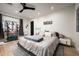 Spacious bedroom with a ceiling fan, queen-sized bed, plush rug, and ample natural light at 7100 N 47Th St, Paradise Valley, AZ 85253