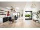 Bright dining room features sleek furnishings, modern light fixture, skylights and backyard views at 7100 N 47Th St, Paradise Valley, AZ 85253