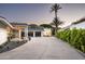 Long driveway leading to a home with a three car garage and desert landscaping at 7100 N 47Th St, Paradise Valley, AZ 85253