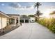 Wide driveway leading to a home with a three car garage and desert landscaping at 7100 N 47Th St, Paradise Valley, AZ 85253