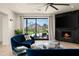 Inviting living area with a fireplace, outdoor views, hardwood floors, and comfortable seating at 7100 N 47Th St, Paradise Valley, AZ 85253