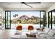 Bright, airy living room with floor-to-ceiling windows offering stunning views of the pool and surrounding landscape at 7100 N 47Th St, Paradise Valley, AZ 85253