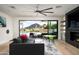 Inviting living room with fireplace, comfortable sofa, and outdoor views of pool and mountains at 7100 N 47Th St, Paradise Valley, AZ 85253