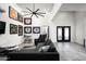Spacious living room offers a cozy sectional sofa, decorative jerseys, ceiling fan, and ample lighting at 7100 N 47Th St, Paradise Valley, AZ 85253