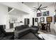 Open-concept living room with a kitchen, dining area, sectional sofa, and expansive lighting at 7100 N 47Th St, Paradise Valley, AZ 85253