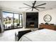 Open and airy main bedroom with fireplace, scenic views, and private patio access at 7100 N 47Th St, Paradise Valley, AZ 85253