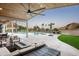 Covered outdoor living space with an outdoor kitchen and inviting patio furniture at 7100 N 47Th St, Paradise Valley, AZ 85253
