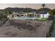 Expansive backyard featuring a modern pool, covered patio, and partially landscaped grounds with mountain views at 7100 N 47Th St, Paradise Valley, AZ 85253
