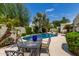 Outdoor dining area with a wrought iron table set near the pool, perfect for entertaining at 7354 E San Miguel Ave, Scottsdale, AZ 85250