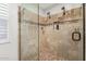 Elegant bathroom featuring a glass shower with dual showerheads and travertine tile at 7354 E San Miguel Ave, Scottsdale, AZ 85250