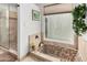 Bathroom featuring a tile shower, soaking tub, and window for lots of natural light at 7354 E San Miguel Ave, Scottsdale, AZ 85250