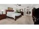 Bright bedroom with neutral carpet, a ceiling fan, and warm wooden furniture at 7354 E San Miguel Ave, Scottsdale, AZ 85250