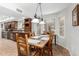 Bright dining area featuring a wooden table, pendant lighting, and large windows, creating an inviting space for meals at 7354 E San Miguel Ave, Scottsdale, AZ 85250