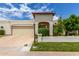 Charming single-story home with a beige stucco exterior, terra cotta tile accents, and a well-manicured front lawn at 7354 E San Miguel Ave, Scottsdale, AZ 85250