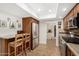 Cozy kitchen featuring wood cabinets, stainless steel appliances, and a breakfast bar with seating at 7354 E San Miguel Ave, Scottsdale, AZ 85250