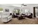 Bright living room featuring comfortable seating, a ceiling fan, and a large window, creating a cozy and inviting atmosphere at 7354 E San Miguel Ave, Scottsdale, AZ 85250