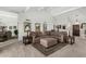 Elegant living room featuring a comfortable sectional sofa, soft carpeting, and natural light, ideal for relaxation and entertaining at 7354 E San Miguel Ave, Scottsdale, AZ 85250