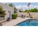 Inviting backyard pool with comfortable patio seating surrounded by lush landscaping, perfect for relaxation at 7354 E San Miguel Ave, Scottsdale, AZ 85250