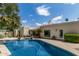 Sparkling pool and patio of this backyard oasis, with desert landscaping and outdoor seating at 7354 E San Miguel Ave, Scottsdale, AZ 85250