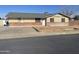 Charming single-story home featuring a well-maintained yard, driveway, and classic brick accents at 742 S Los Alamos --, Mesa, AZ 85204