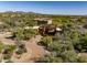 Aerial view of a desert home with a terracotta roof and professional desert landscaping at 7547 E Mary Sharon Dr, Scottsdale, AZ 85266