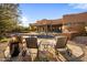 Beautiful backyard featuring a pool, lounge chairs, outdoor grill and fireplace, set against a backdrop of a Southwestern home at 7547 E Mary Sharon Dr, Scottsdale, AZ 85266