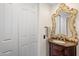Bathroom featuring an ornate mirror, marble vanity, and vintage-style fixtures at 7547 E Mary Sharon Dr, Scottsdale, AZ 85266