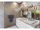 Elegant bathroom featuring double sinks, granite counters and decorative mirrors at 7547 E Mary Sharon Dr, Scottsdale, AZ 85266