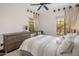 Cozy bedroom with a comfortable bed, dresser, and natural light from the two windows at 7547 E Mary Sharon Dr, Scottsdale, AZ 85266